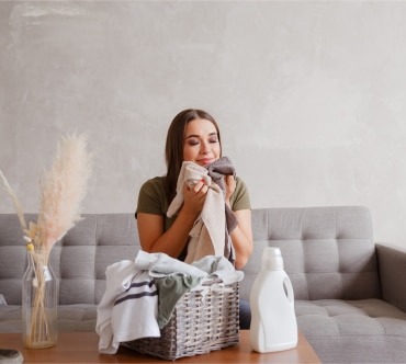 girl smelling cloths